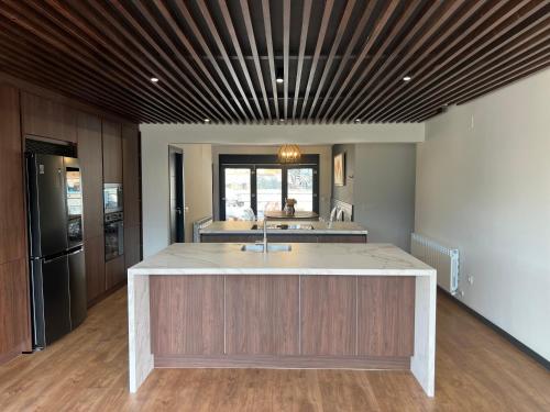 a kitchen with a large island in the middle at Faro de Gredos in Arenas de San Pedro