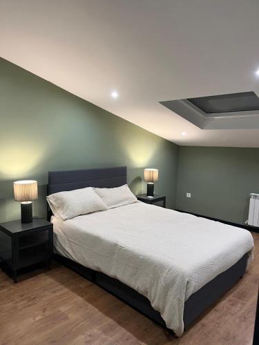 a bedroom with a large bed with two night stands at Faro de Gredos in Arenas de San Pedro
