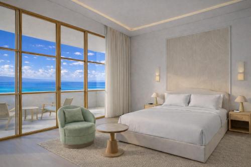 a bedroom with a bed and a chair and a large window at The Bristol Bol - NEW IN 2026 in Bol