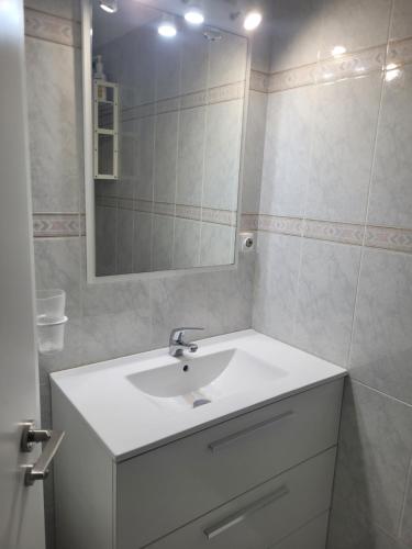 a bathroom with a white sink and a mirror at Torrenostra PLATJA in Torrenostra