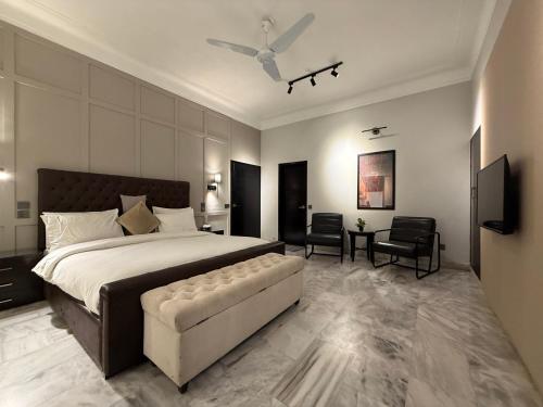 a large bedroom with a large bed and a couch at Ghumo - 10BR Villa in Bahadurabad near Aga Khan in Karachi