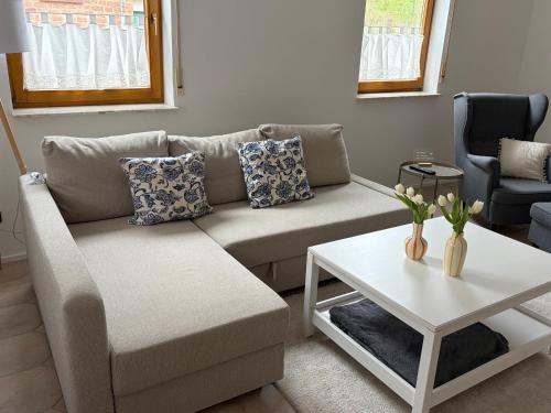 a living room with a couch and a table at Ferienwohnung Sensbachtal in Untersensbach