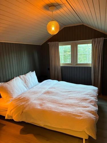 a bedroom with a large white bed in a room at Drangedal Cabin House in Drangedal