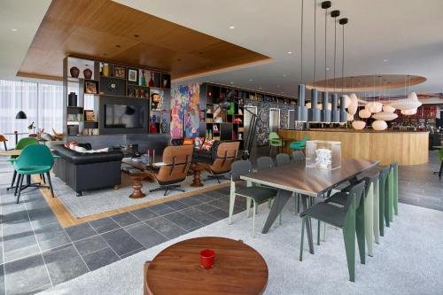 a living room with a table and chairs at citizenM London Shoreditch in London