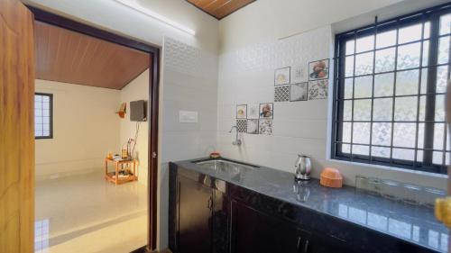 a kitchen with a counter and a large window at Sea shells on the seashore in Cocoanut Island
