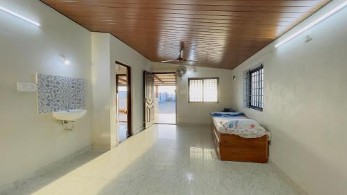 a room with a bed and a sink in it at Sea shells on the seashore in Cocoanut Island
