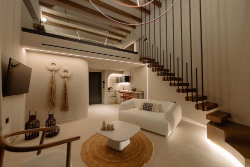 a living room with a white couch and a table at Kyklio Pavilions in Nafplio