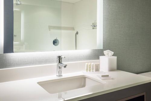 a bathroom with a white sink and a mirror at Residence Inn by Marriott Boston Braintree in Braintree