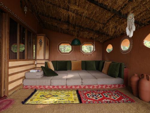 a bedroom with a bed in a room with windows at Taiga Forest Mountain Tree house in Wayanad