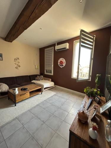 a living room with a couch and a table at Appartement Bellegarde in Bellegarde