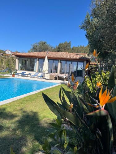 a villa with a swimming pool and a house at The Pool House in Longos