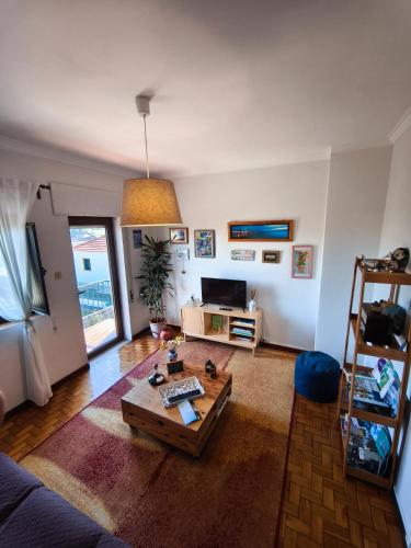 a living room with a couch and a table at Casa das Flores in Santo Tirso