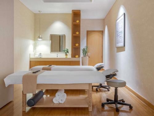 a hospital room with a bed and a mirror at Swissôtel Living Al Ghurair Centre Dubai in Dubai
