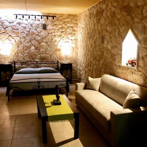 a living room with a bed and a couch at Sarantos Pool Suites in Lakíthra