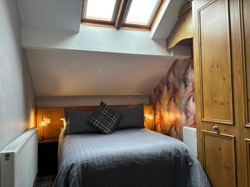 a bedroom with a bed in a small room at Cumbrian Lodge in Seascale