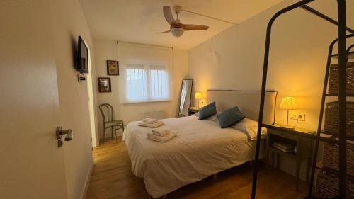 a bedroom with a bed and a ceiling fan at La Casita de Rosa Sierra de Francia - Cozy Rural House with Fireplace in Aldeanueva de la Sierra