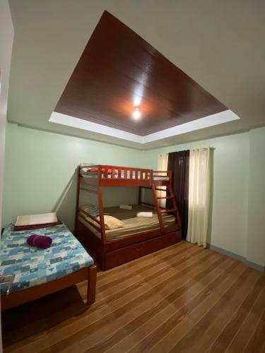 a room with a bunk bed and a bed at Tiny Home fronting Alburquerque Church in Alburquerque