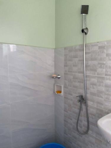a bathroom with a shower and a sink at Tiny Home fronting Alburquerque Church in Alburquerque