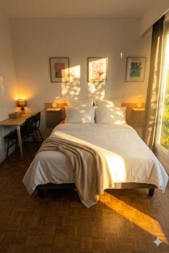 a bedroom with a large white bed and a desk at Studio in a luxury community in Nice