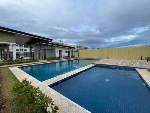 a large swimming pool in front of a building at Leina Life-Style Comfy Studio Balcony near Mactan Airport in Bankal