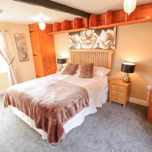 a bedroom with a large bed in a room at Butterswood Lakes in Goxhill