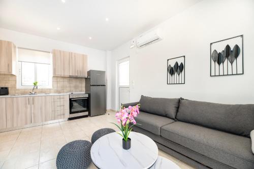 a living room with a couch and a table at Azure Edge - Seafront View - Beach Stay in Tigaki