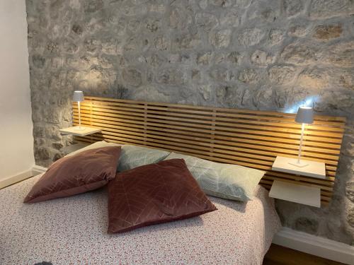 a bedroom with a bed with two pillows on it at Appartamento Scaligeri in Venzone