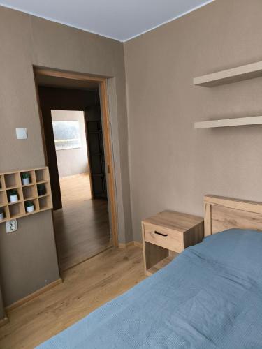 a bedroom with a bed and a mirror and a hallway at Apartment GLORIA in Narva-Jõesuu