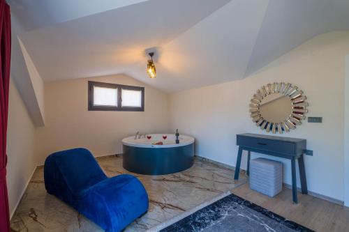 a large bathroom with a tub and a mirror at Villa Huzur in Fethiye