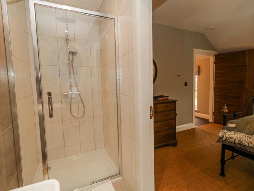 a bathroom with a shower with a glass door at Cloneytrace Mines in Ballymena