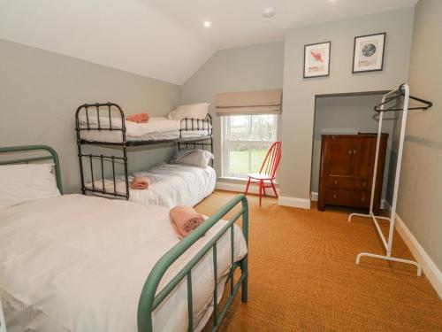 a bedroom with two bunk beds and a window at Cloneytrace Mines in Ballymena