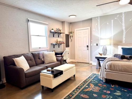 a living room with a couch and a bed at Set on peaceful 5 acres, 5 min from town, Private Building, Level 2 EV Charger in Bloomington