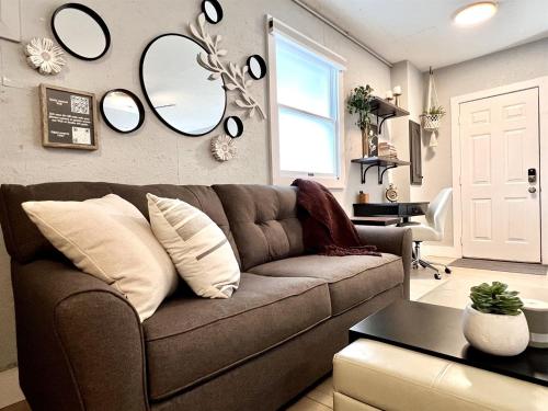 a living room with a couch and mirrors on the wall at Set on peaceful 5 acres, 5 min from town, Private Building, Level 2 EV Charger in Bloomington