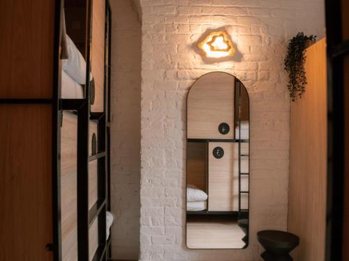 a room with a mirror on the wall at Gardiner House Hostel in Dublin