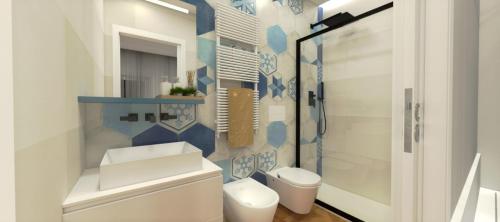 a white bathroom with a toilet and a shower at Suite Enea San Rocco in Sperlonga