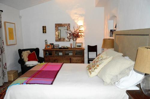 a bedroom with a bed and a dresser and a mirror at Monte da Boavista - Country family house in Alter do Chão