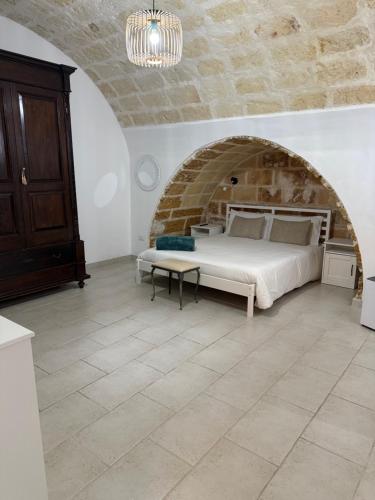 a bedroom with a bed and a stone wall at Casa Angel in Mesagne