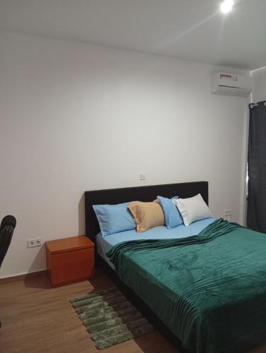 a bedroom with a bed with two pillows on it at T&S Guest House in Praia