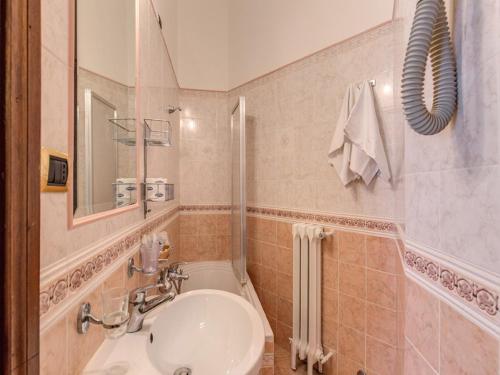 a bathroom with a sink and a toilet and a mirror at Hotel Labelle in Rome