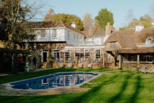 a large house with a swimming pool in the yard at Crafted at Powdermills in Battle