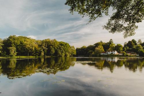 a large lake with a house in the middle at Crafted at Powdermills in Battle