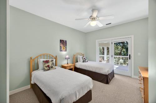 a bedroom with two beds and a ceiling fan at SM04: 4 Silver Moss in Kiawah Island