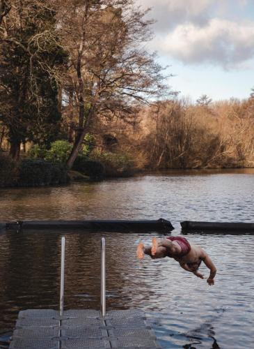 a man is swimming in a body of water at Crafted at Powdermills in Battle