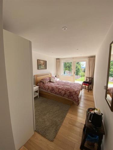 a bedroom with a bed and a large window at Timbers in Truro