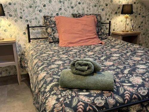 a bedroom with a bed with a towel on it at Suite La Clé de la Liberté Maison Like and Love 25m2 avec coin salon in Duclair