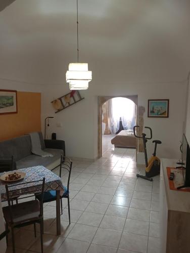 a living room with a couch and a table at Da Adriana NETUM in Noto
