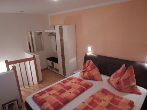 a room with a bed with two pillows on it at Haus Pfeiffenberger in Eben im Pongau