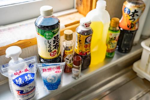 a shelf filled with bottles of food and drinks at Rishiri Antique Inn in Rishiri
