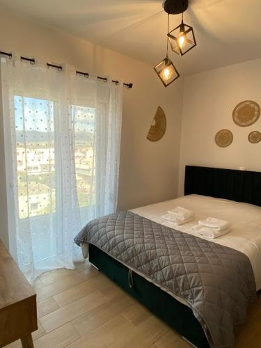a bedroom with a bed and a large window at Anastasia Karystos in Karistos