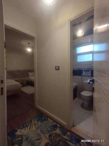 a bathroom with a toilet in a room at Rafifi pyramids inn view in Cairo
